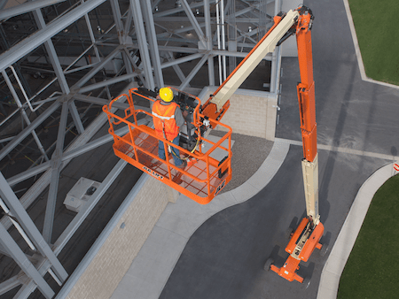 man standing on raised crane